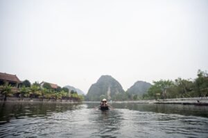 cruising through limestone cliffs in Ninh Binh Vietnam